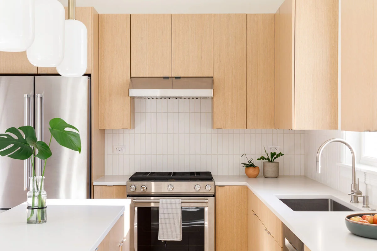how to match your kitchen countertops with the right tiles | light marble countertop with white subway tiles