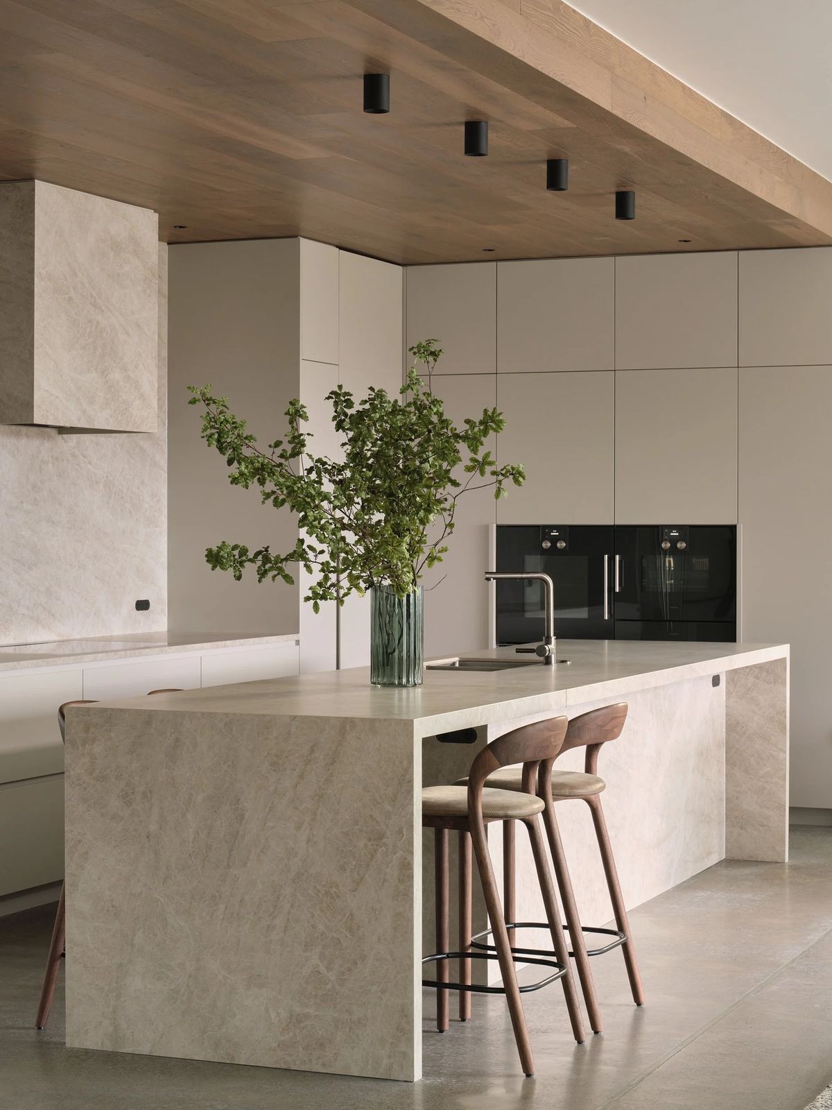Kitchen with warm wood accents and natural stone-look tiles